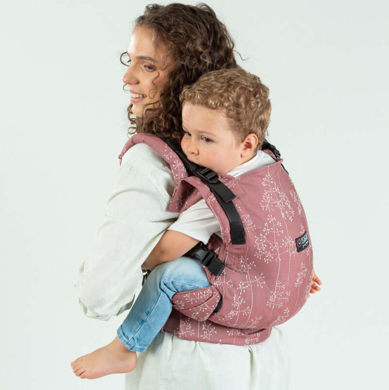 Isara The One - Meadow Grass baby carrier in use, toddler comfortably seated, ideal for family adventures | Babymaxi