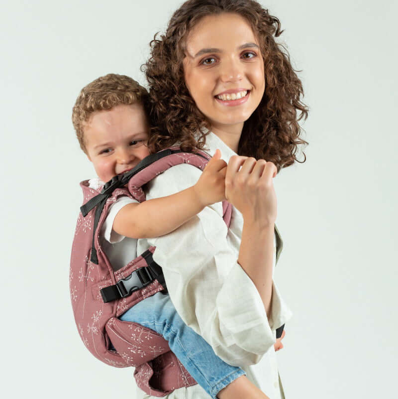Isara The One - Meadow Grass baby carrier with a smiling child on parent's back, perfect for all body types | Babymaxi