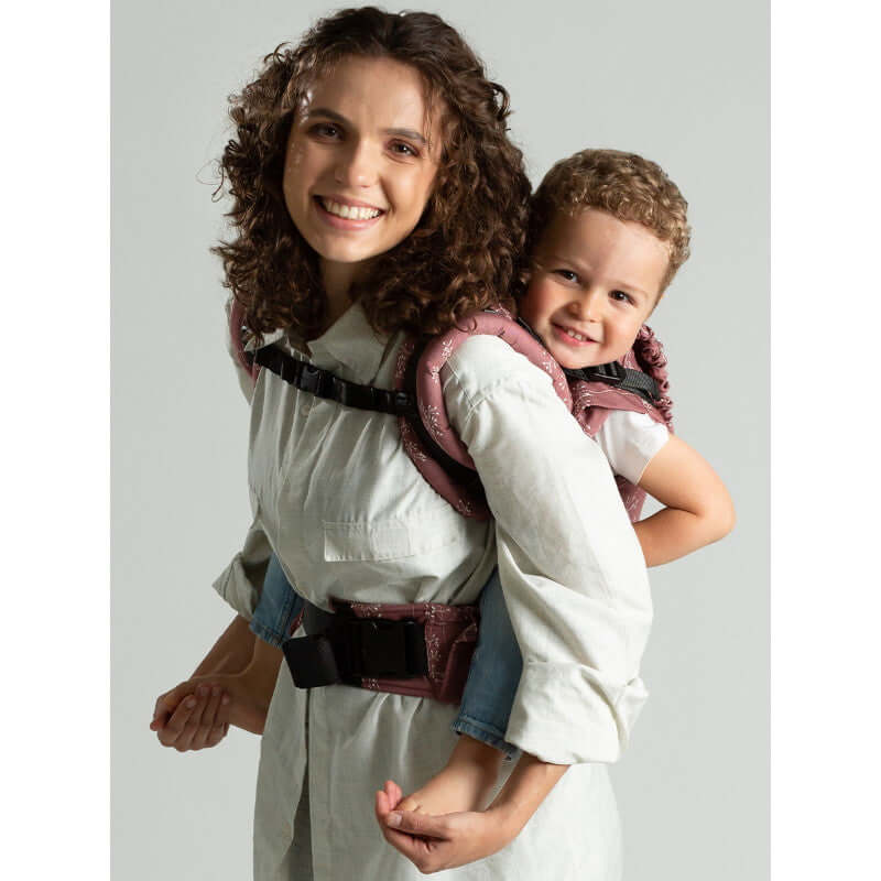 Isara The One - Meadow Grass baby carrier in use, supporting a toddler comfortably on mom's back | Babymaxi