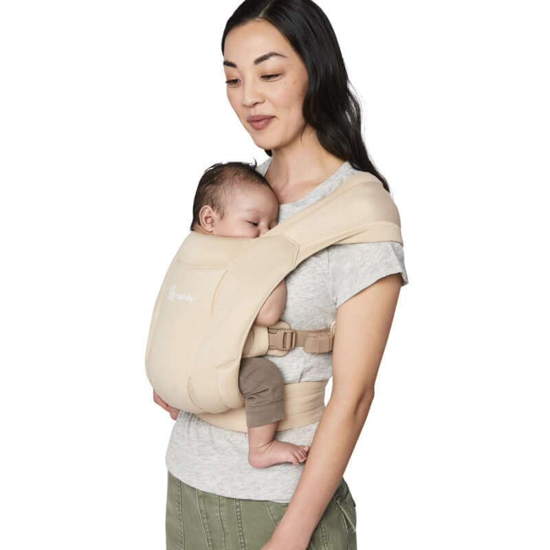 Mom comfortably carries baby in Ergobaby Embrace Soft Air Mesh - Cream for secure and breathable support | Babymaxi