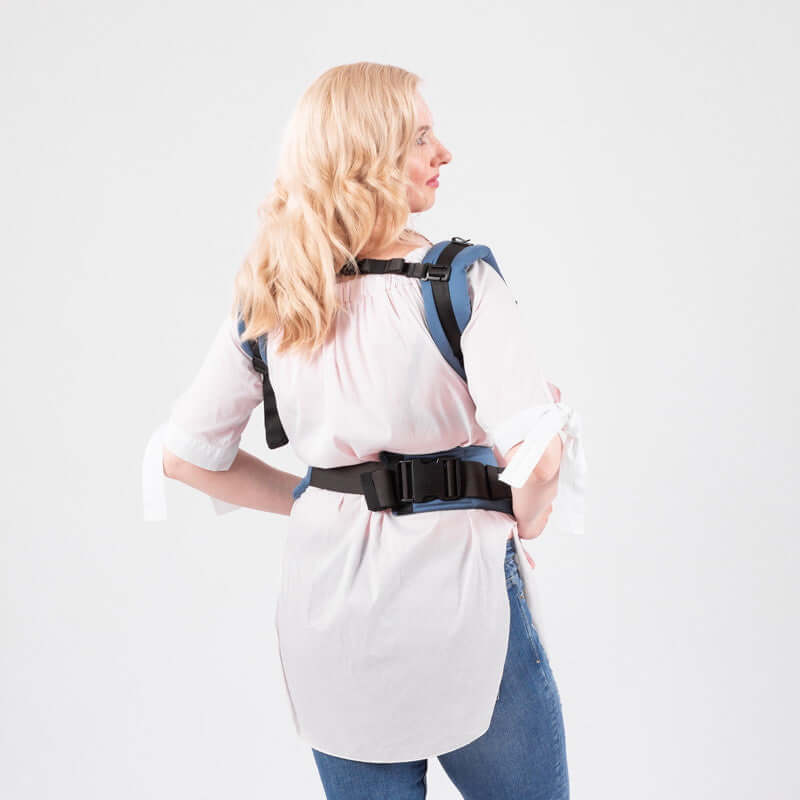 Isara The One - Bluestone ergonomic baby carrier shown on a model demonstrating the adjustable straps | Babymaxi