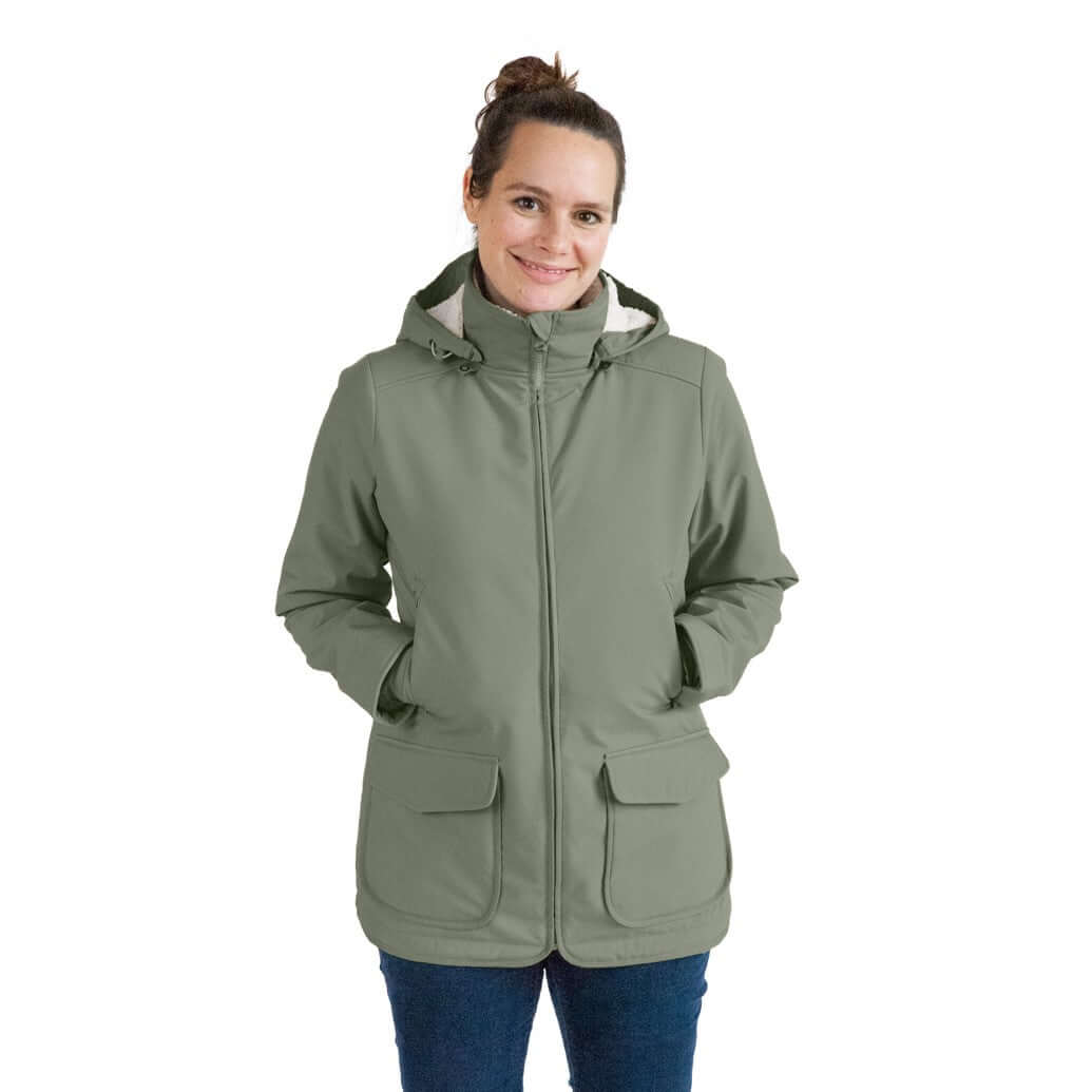 Mamalila Winter Softshell Baby Carrier Jacket - Agave worn by a woman, featuring a stylish design and cozy pockets | Babymaxi