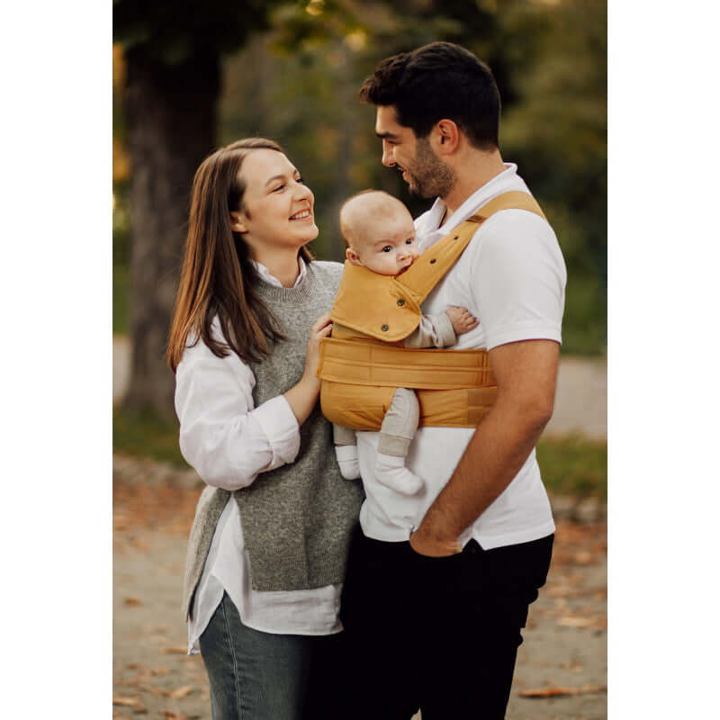 Marsupi Classic - Butterscotch baby carrier in use by parents with baby, ergonomic design for comfortable babywearing | Babymaxi