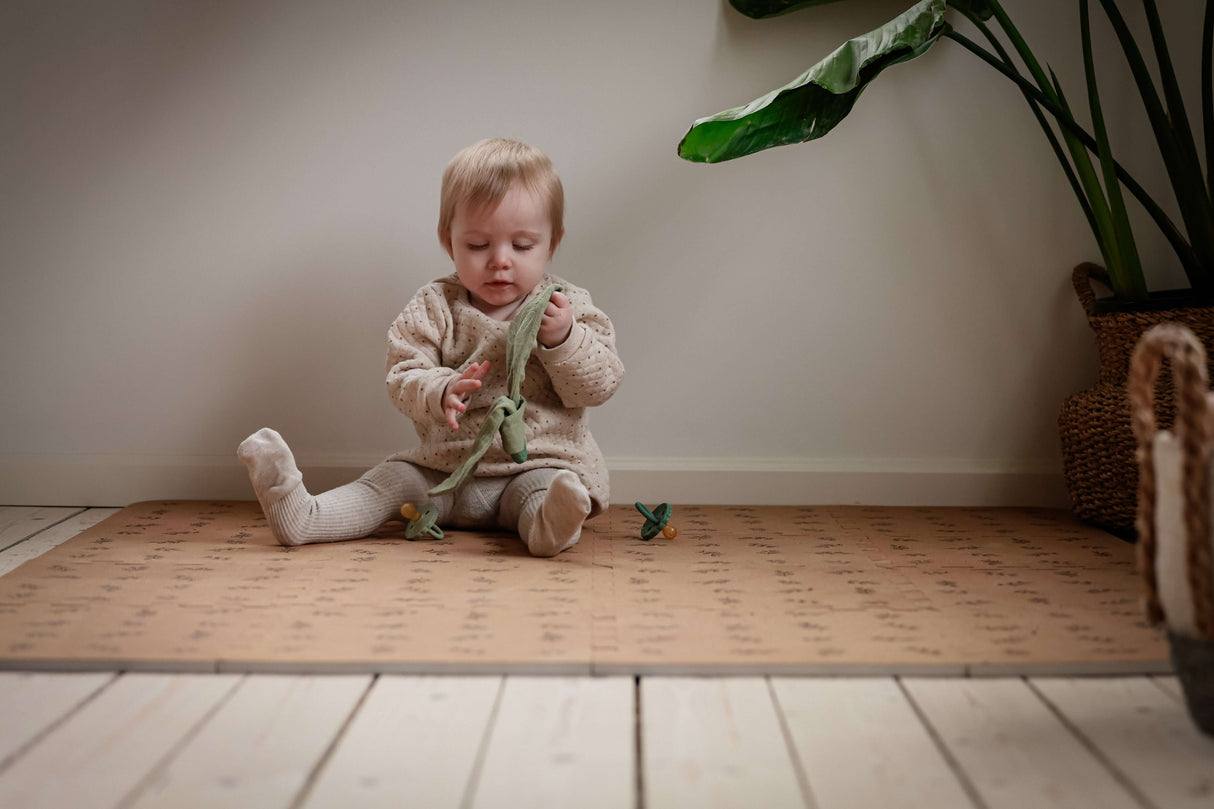 Organic Baby Teether & Activity Toy – Perfect for Carriers in use by a happy baby on a playmat | Babymaxi