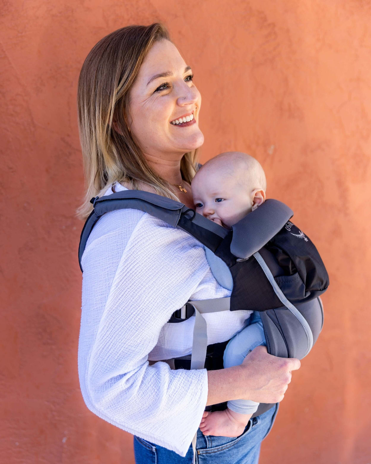 Mom using Osprey Poco Soft Child Carrier LT - Black with baby, showcasing comfort and safety | Babymaxi