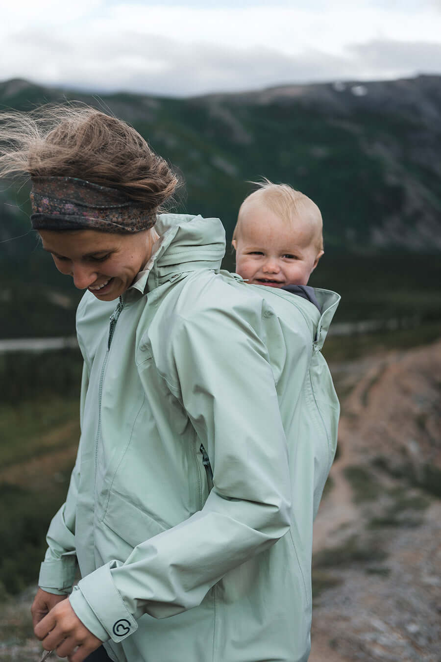 Mamalila Explorer Outdoor Baby Carrier Jacket - Mint in action with happy baby on mother's back | Babymaxi