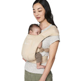 Mom comfortably carries baby in Ergobaby Embrace Soft Air Mesh - Cream for secure and breathable support | Babymaxi