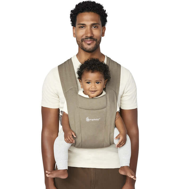 Ergobaby Embrace - Soft Olive baby carrier in use with father holding baby securely | Babymaxi
