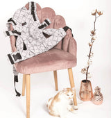Isara The One - Diamonda Grey baby carrier on a pink chair with a cat | Babymaxi