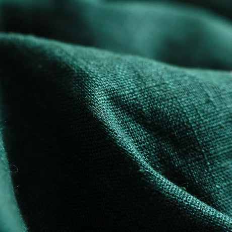 Close-up of ISARA The One - Evergreen Linen fabric, showcasing its soft texture and rich green color | Babymaxi
