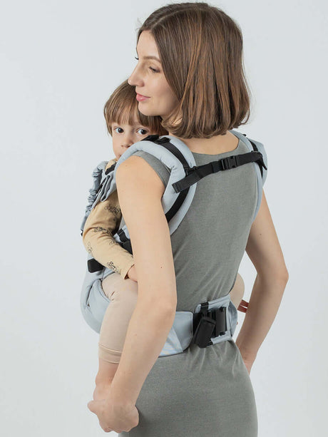 Isara The One - Pearl Grey baby carrier shown with parent carrying child comfortably and securely | Babymaxi