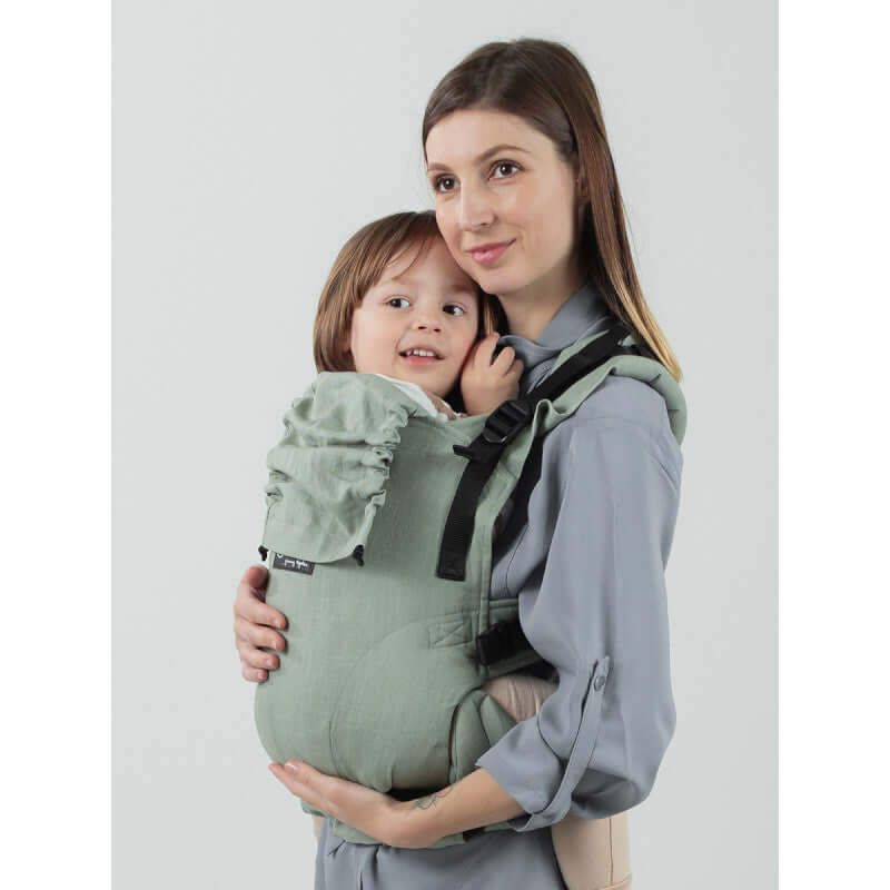Isara The One - Sage Green Linen baby carrier featuring a mother and child, showcasing soft, stylish design | Babymaxi