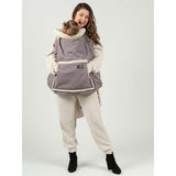 Woman wearing Isara Winter Baby Carrier Cover - Frosted Almond Taupe, keeping baby warm and cozy | Babymaxi