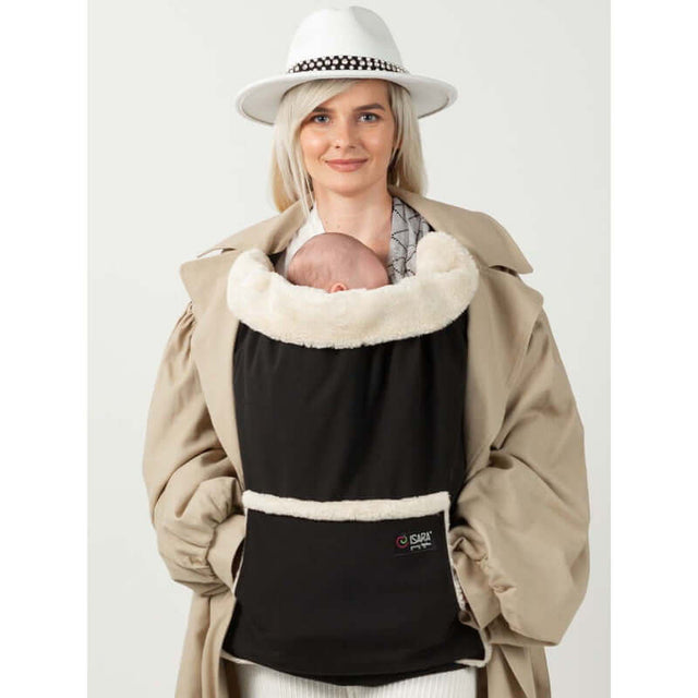 Woman wearing Isara Winter Baby Carrier Cover - Ultra Black, keeping baby warm in cozy fleece during winter.| Babymaxi