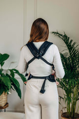 LennyLamb LennyLight - Ebony Black baby carrier on a woman, showing adjustable straps and lightweight design | Babymaxi