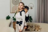 LennyLamb LennyPreschool (up to 30kg) - Little Herringbone Ebony Black toddler carrier in use with a parent and child| Babymaxi