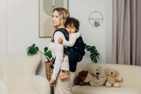 Mom using LennyLamb LennyPreschool (up to 30kg) - Little Herringbone Ebony Black carrier with toddler on her back | Babymaxi
