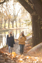 Mamalila Eco Wool Babywearing Coat Oslo - Camel worn by mothers in nature, showcasing babywearing and autumn vibes | Babymaxi