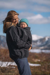 Mamalila Explorer Outdoor Baby Carrier Shell Jacket - Black in use by a mother carrying her baby during an outdoor hike | Babymaxi