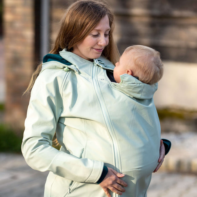 Mamalila Softshell Babywearing Jacket Allrounder - Mint in use by a mother carrying her baby | Babymaxi