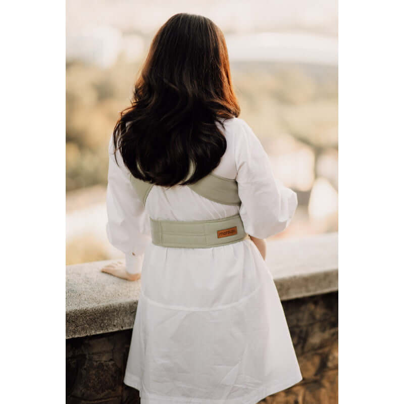 Marsupi Breeze - Pistachio baby carrier worn by a woman outdoors, showcasing ergonomic design | Babymaxi