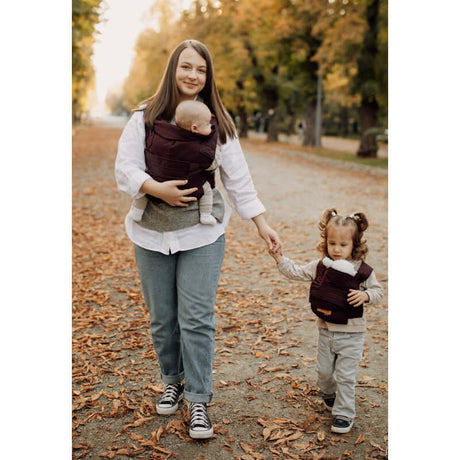 Marsupi Classic - Berry baby carrier in use by a mom, walking with a toddler, enjoying autumn leaves | Babymaxi