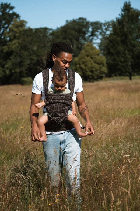 Woman enjoying outdoor moment with baby secured in Nomad Air jaguar carrier