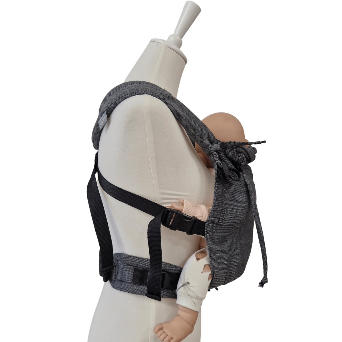 Stochenwiege Valeno Baby Carrier - Graphite on mannequin holding a baby doll, showcasing ergonomic design | Babymaxi