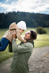 Mamalila Softshell Babywearing Jacket Allrounder Fit Agave, mom lifting her toddler outdoors, solo wear