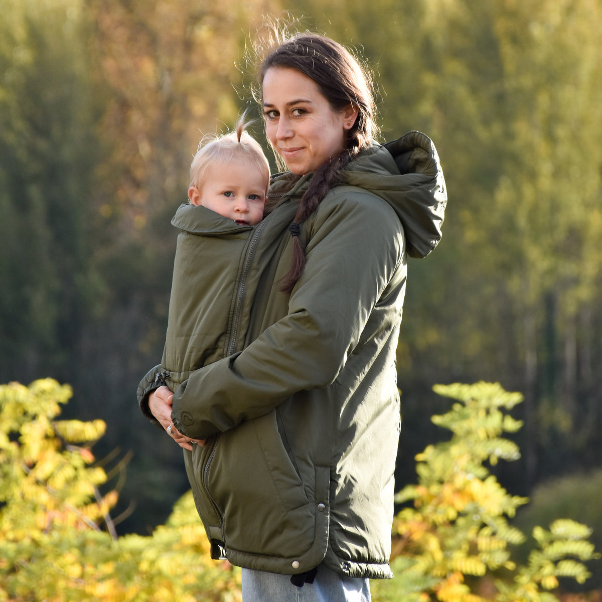 Mamalila Boston Babywearing Jacket Olive, side view of front carry with baby insert and hood